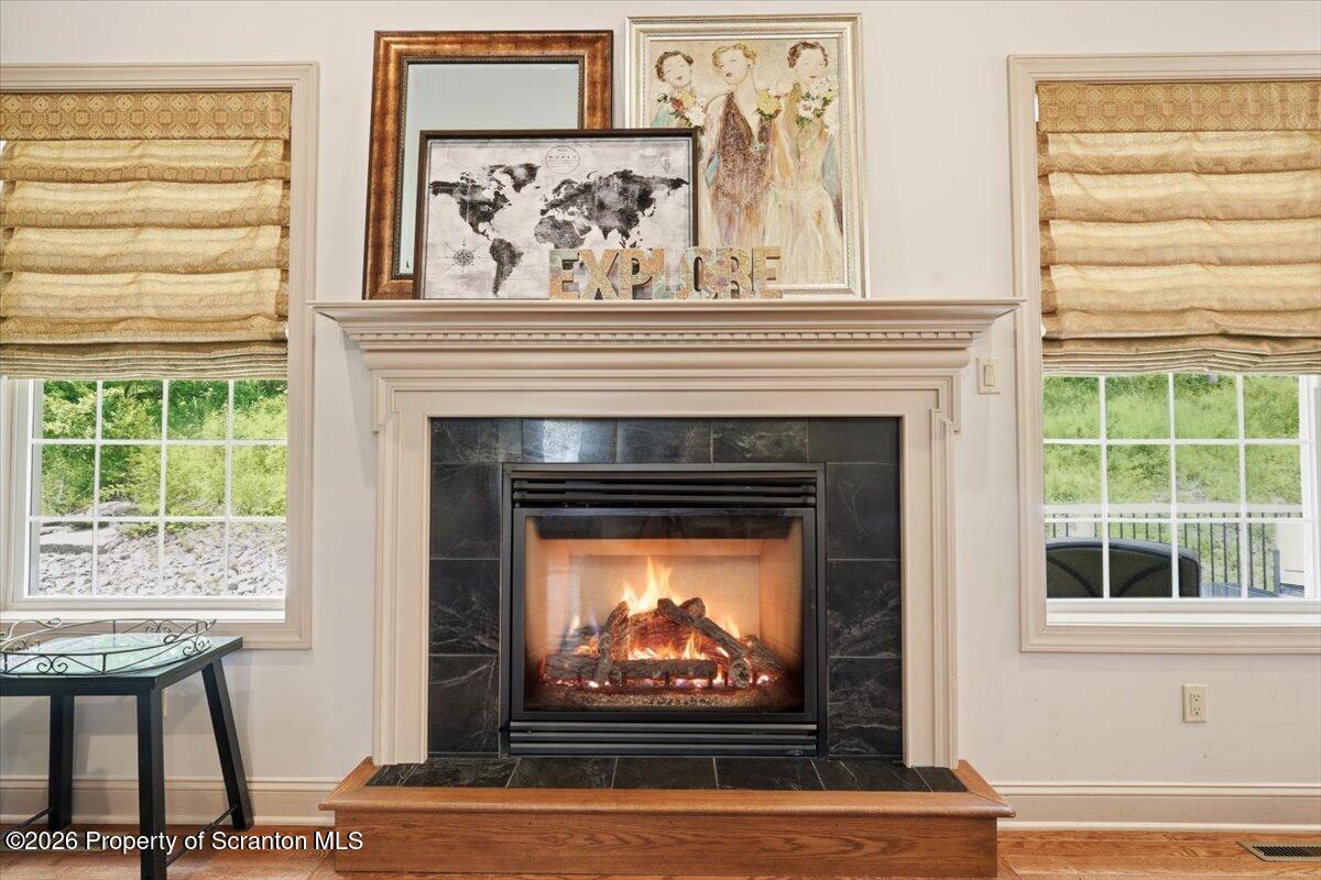 99 Hilltop Road Waverly, PA 18471 - Photo 9 of 41 a living room with a fireplace and a window