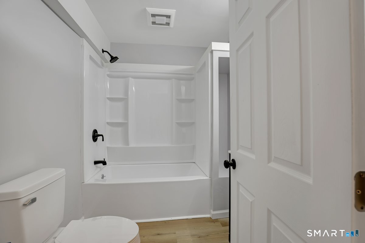 192 Hartford Road, Unit F Manchester, CT 06040 - Photo 8 of 8 a bathroom with a bathtub and a toilet