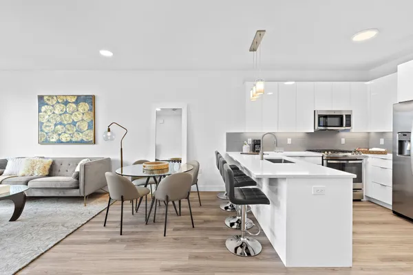 a view of a dining room with furniture and a kitchen