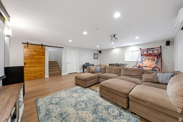 7776 Wagon Road East St. George, UT 84770 - Photo 36 of 76 Living room with a barn door, light wood-style flooring, and recessed lighting