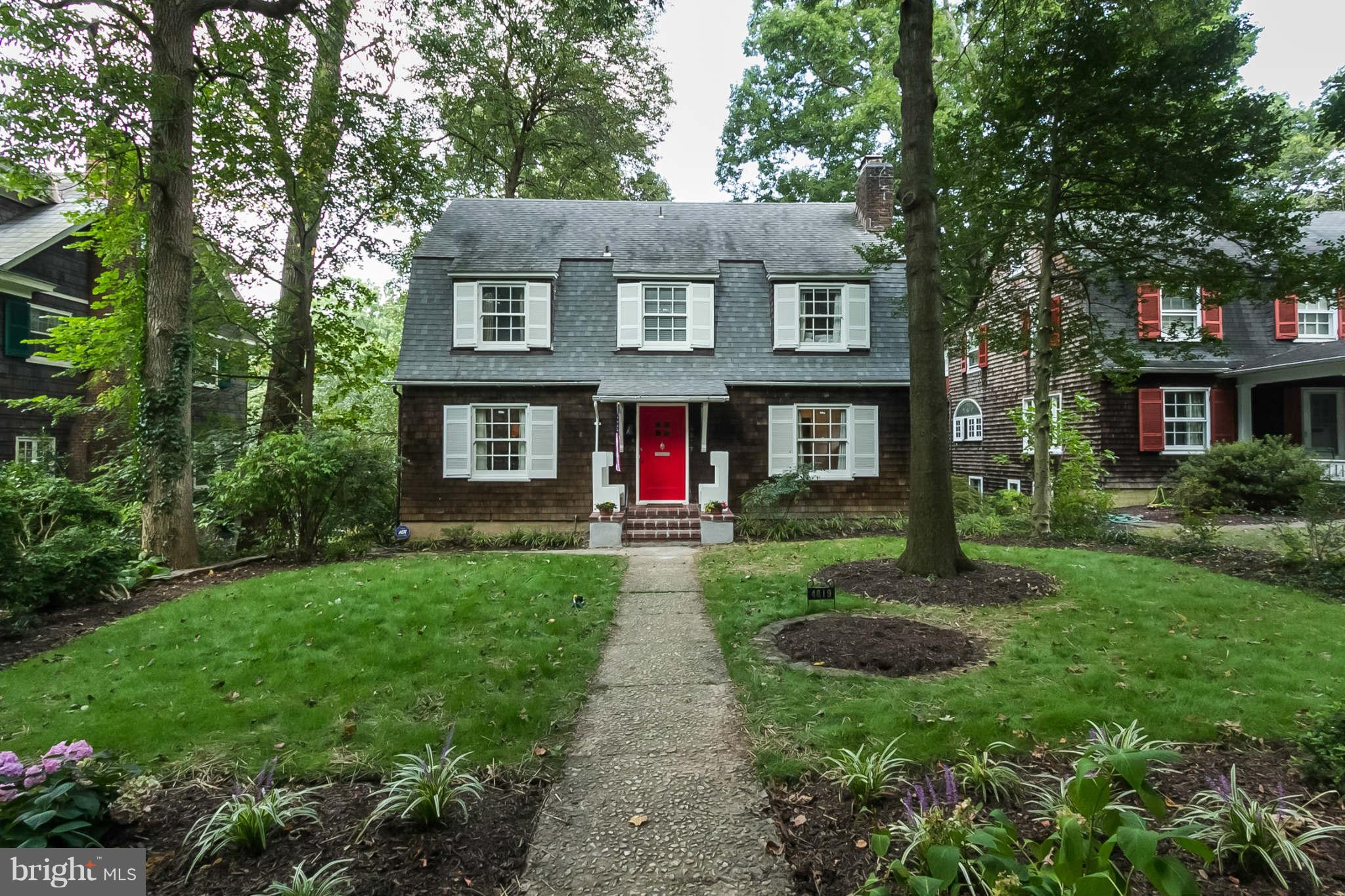 4819 Keswick Road Baltimore, MD 21210 - Photo 1 of 28 a view of a brick house with a yard plants and large tree