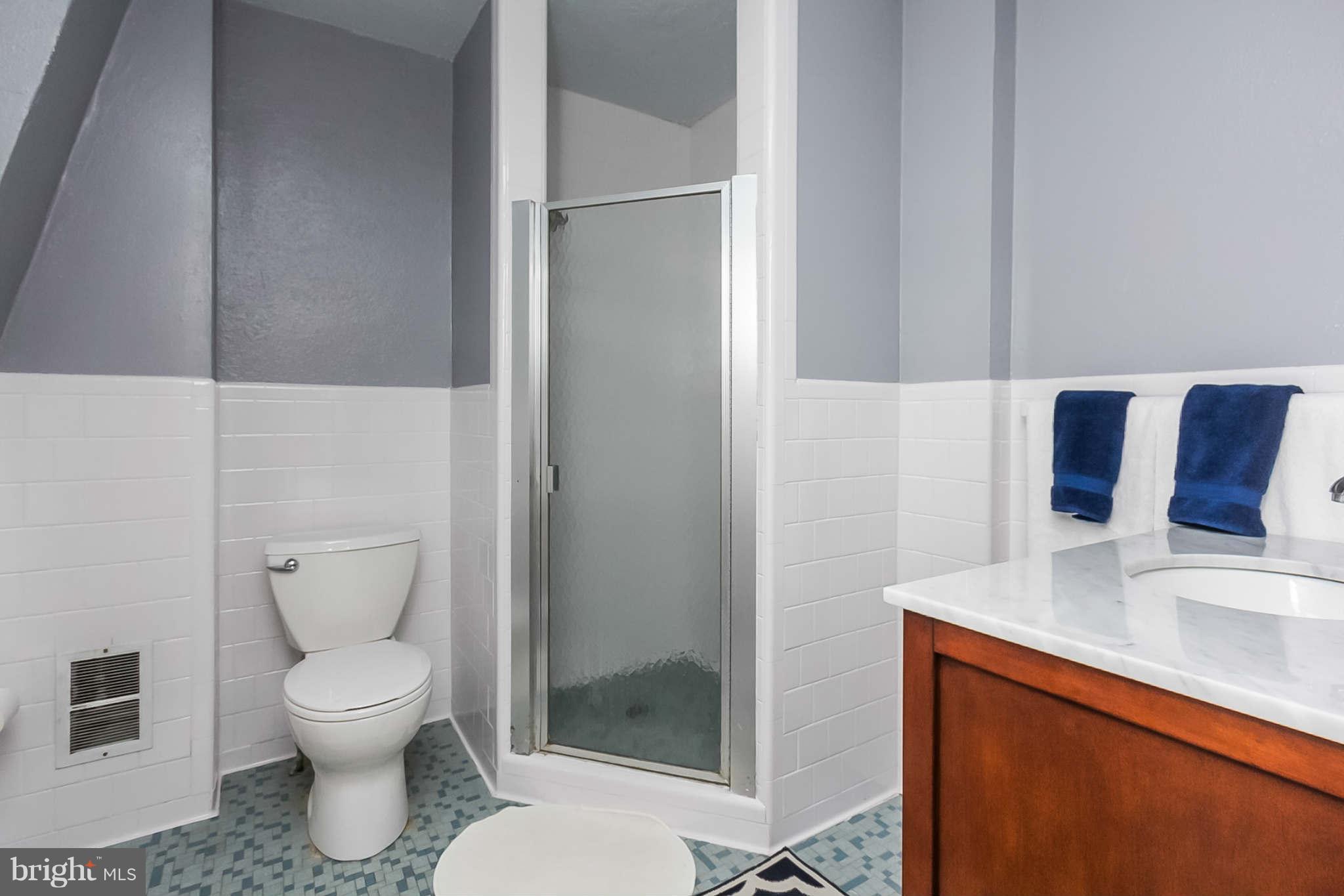 4819 Keswick Road Baltimore, MD 21210 - Photo 17 of 28 a bathroom with a toilet sink and shower