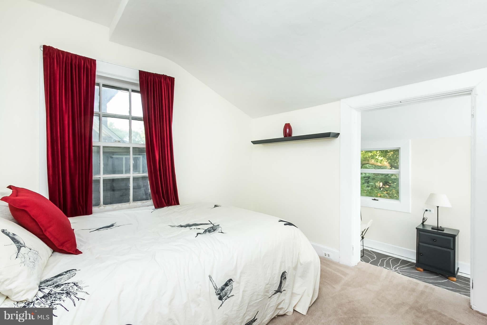 4819 Keswick Road Baltimore, MD 21210 - Photo 22 of 28 a bedroom with a bed and wooden floor