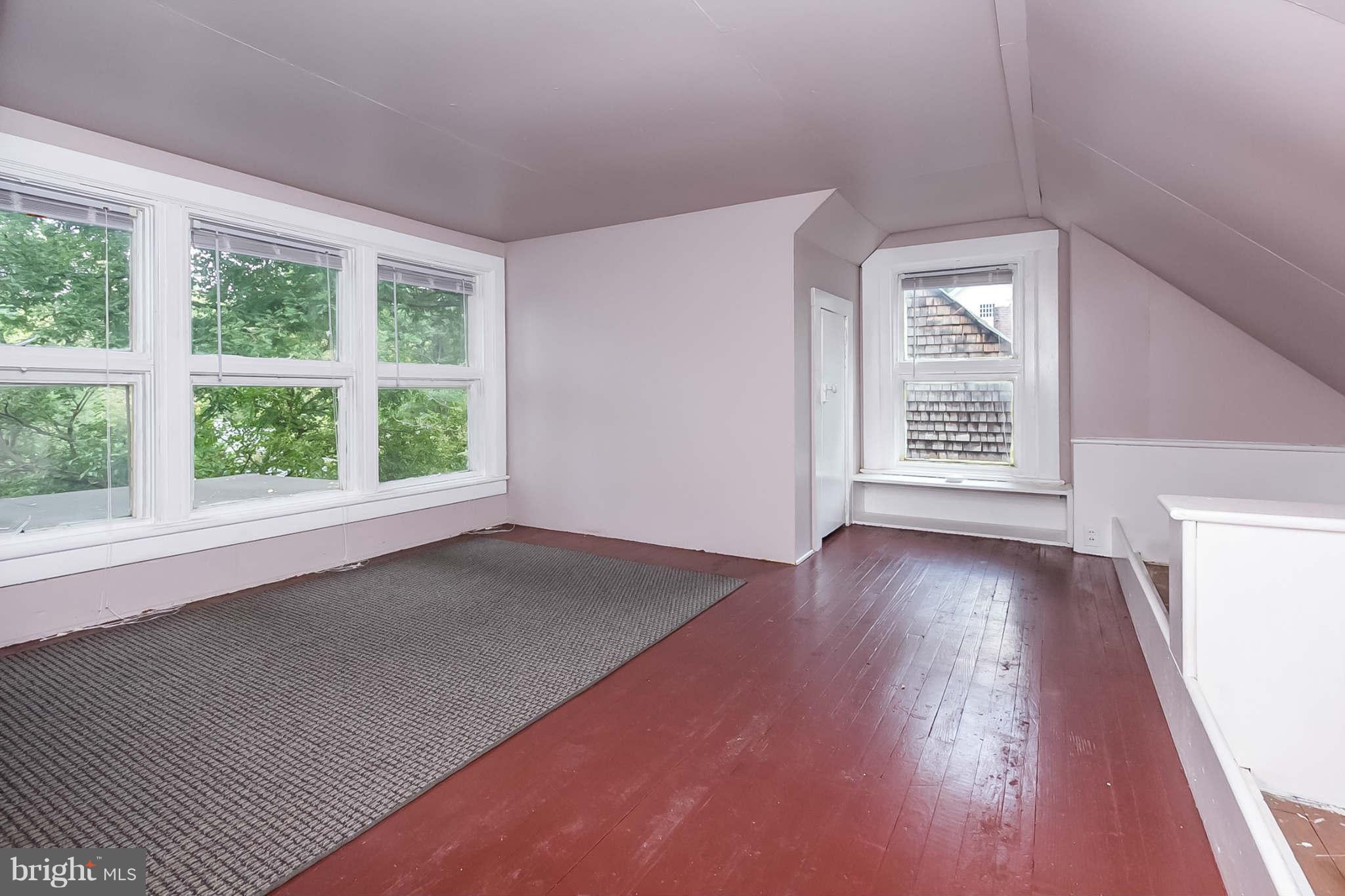 4819 Keswick Road Baltimore, MD 21210 - Photo 26 of 28 an empty room with wooden floor and windows