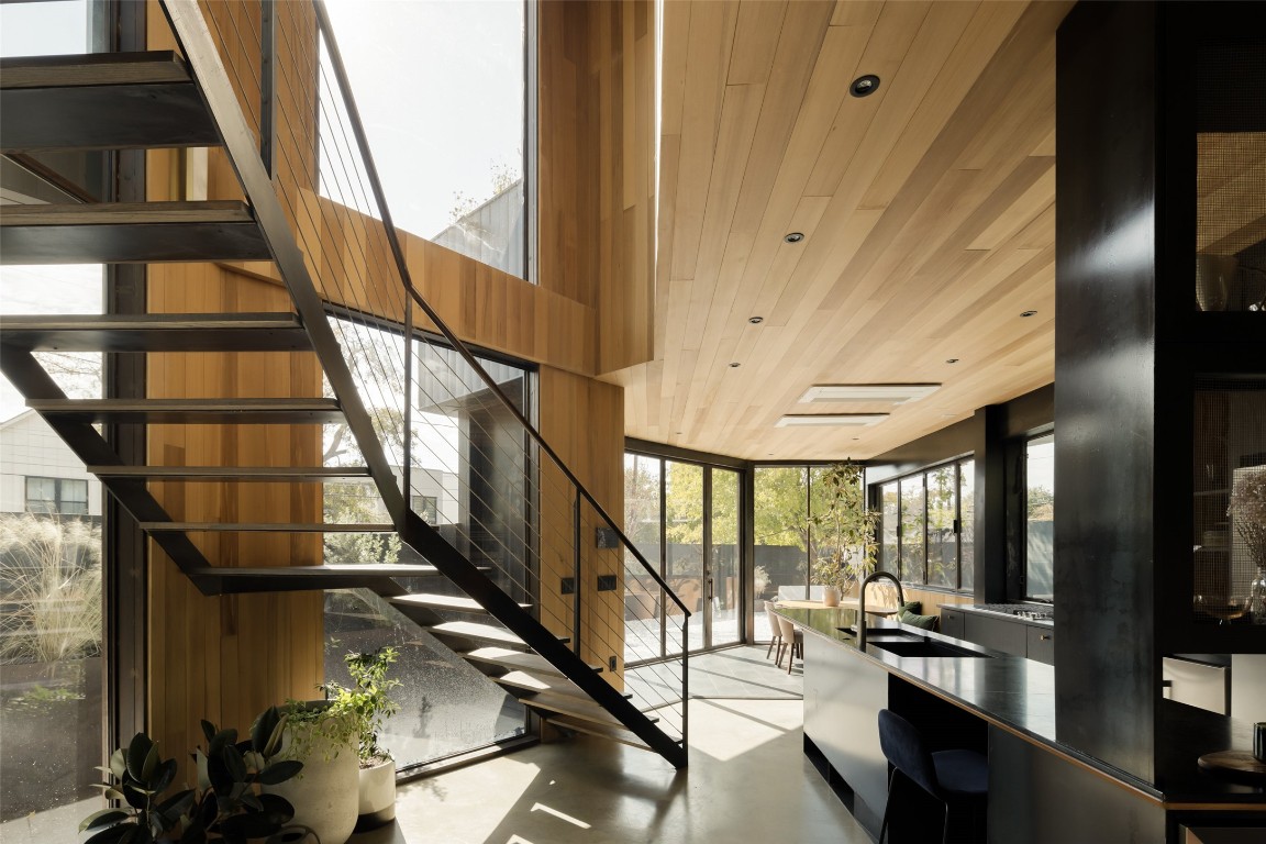 2302 East 11th Street Austin, TX 78702 - Photo 21 of 40 a view of staircase with lots of frames on wall and a large window