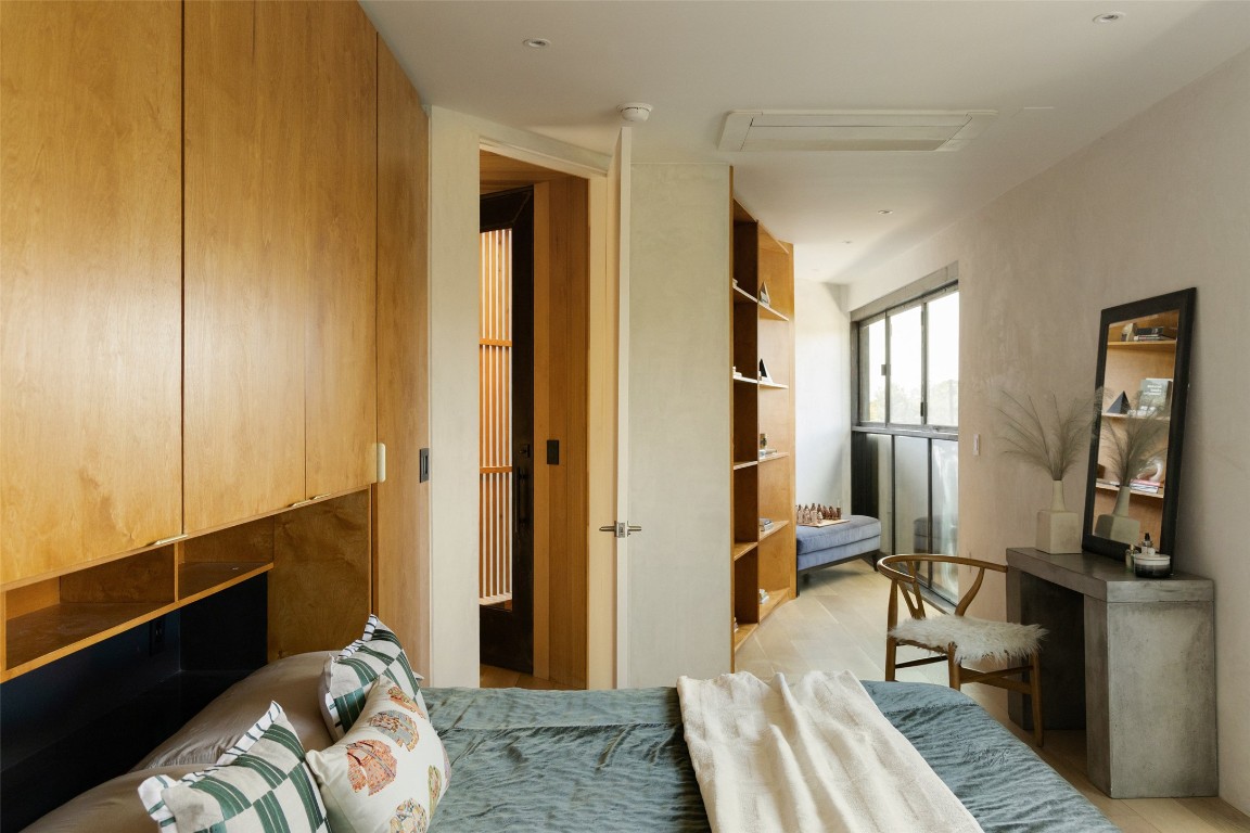 2302 East 11th Street Austin, TX 78702 - Photo 31 of 40 a bedroom with a bed and wooden floor