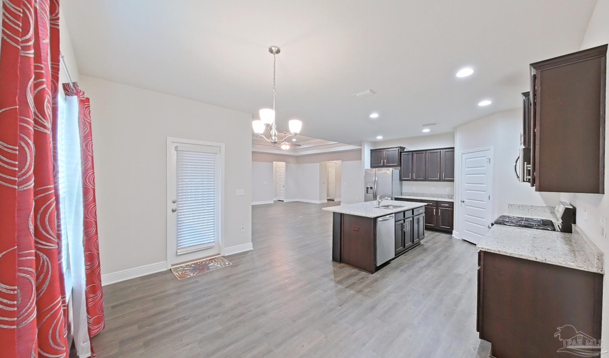 633 Harahan Lane Foley, AL 36535 - Photo 13 of 57 a large kitchen with a sink and a stove top oven with wooden floor
