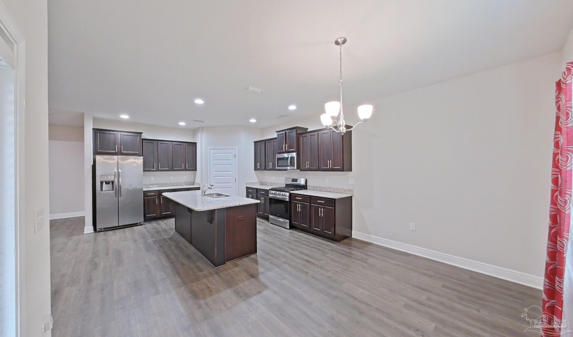 633 Harahan Lane Foley, AL 36535 - Photo 14 of 57 a kitchen with stainless steel appliances granite countertop a sink dishwasher a refrigerator and a wooden floor
