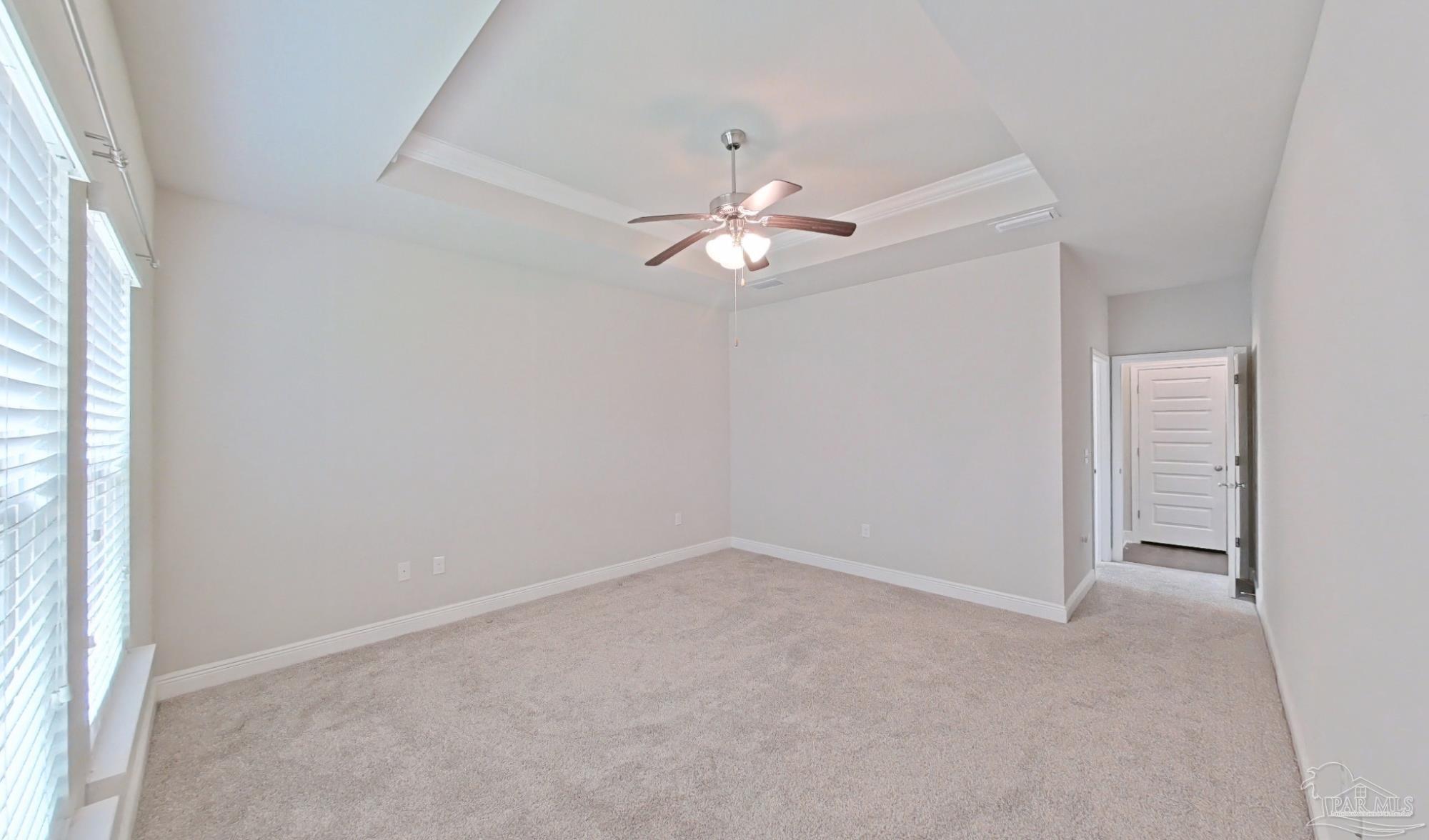 633 Harahan Lane Foley, AL 36535 - Photo 21 of 57 an empty room with a chandelier fan and windows