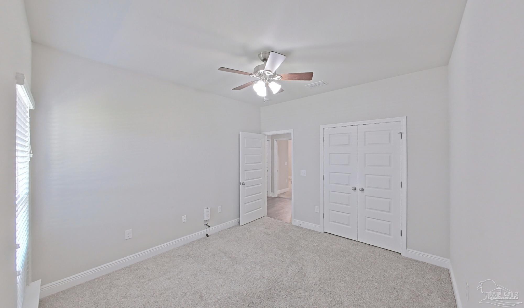 633 Harahan Lane Foley, AL 36535 - Photo 43 of 57 an empty room with closet and a ceiling fan