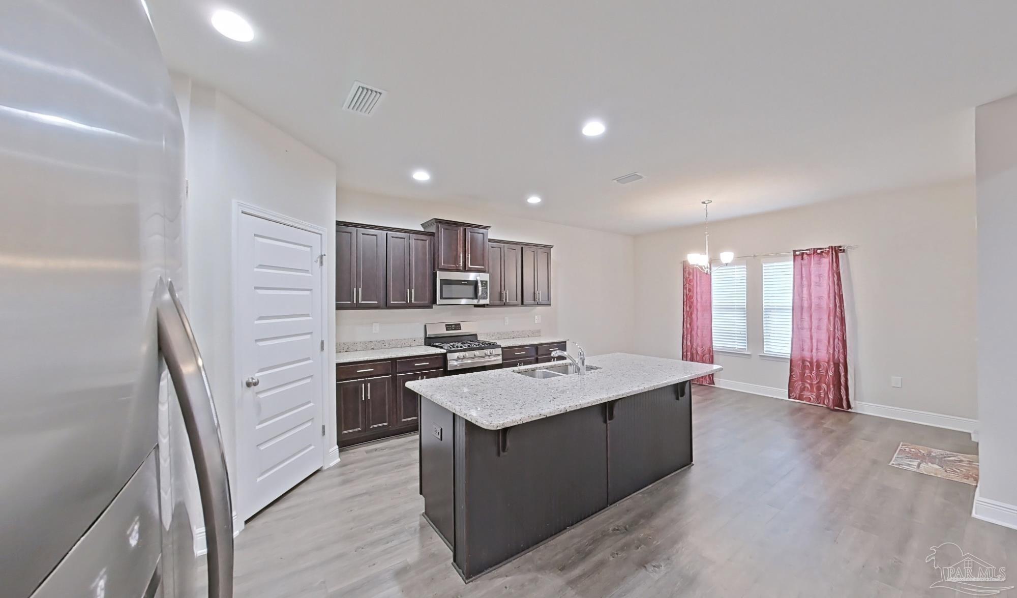 633 Harahan Lane Foley, AL 36535 - Photo 8 of 57 a kitchen with a stove sink and a refrigerator