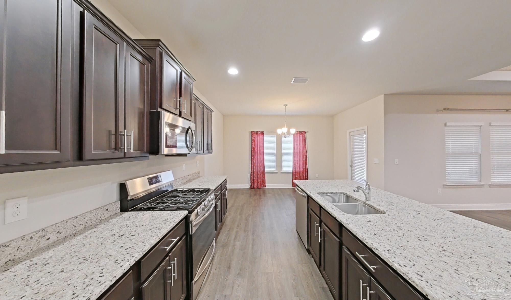 633 Harahan Lane Foley, AL 36535 - Photo 10 of 57 a kitchen with stainless steel appliances granite countertop a sink and stove