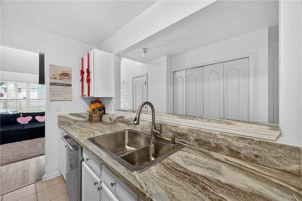 175 Gross Lake Parkway Covington, GA 30016 - Photo 12 of 25 a kitchen with a sink cabinets and appliances