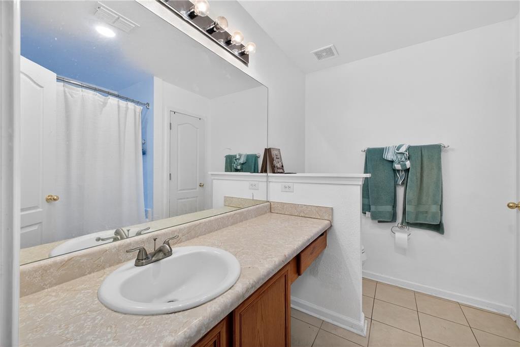 175 Gross Lake Parkway Covington, GA 30016 - Photo 16 of 25 a bathroom with a sink and a mirror