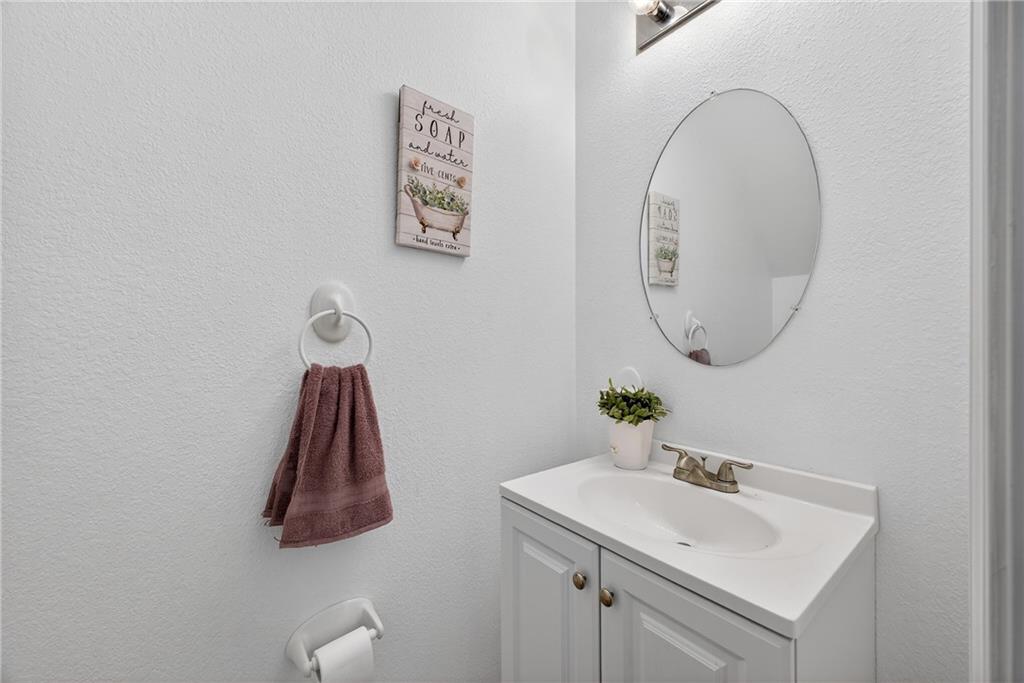175 Gross Lake Parkway Covington, GA 30016 - Photo 17 of 25 a bathroom with a sink and a mirror