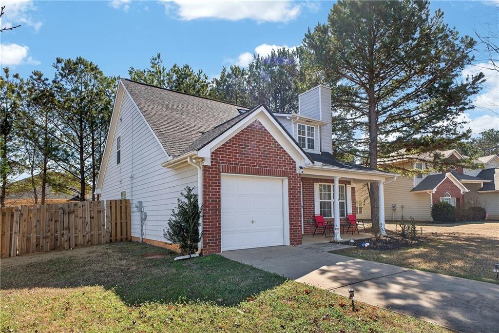 175 Gross Lake Parkway Covington, GA 30016 - Photo 3 of 25 a view of a house with a yard and large tree