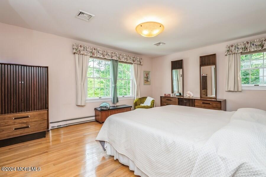 33 Bucks Mill Road Colts Neck, NJ 07722 - Photo 18 of 33 a spacious bedroom with a bed and a large window