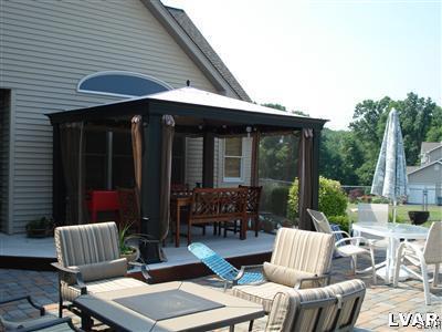 231 Kellington Road Wind Gap, PA 18091 - Photo 12 of 48 a view of a patio with a dining table and chairs with wooden floor