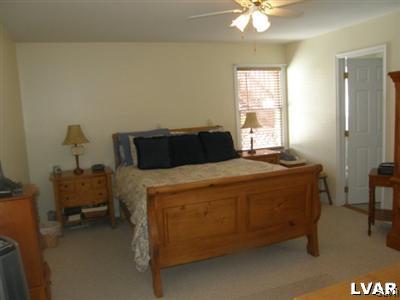 231 Kellington Road Wind Gap, PA 18091 - Photo 22 of 48 a bedroom with a bed and a chandelier
