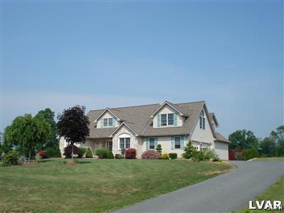 231 Kellington Road Wind Gap, PA 18091 - Photo 3 of 48 a front view of a house with a garden and trees