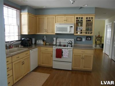 231 Kellington Road Wind Gap, PA 18091 - Photo 36 of 48 a kitchen with stainless steel appliances granite countertop a stove a sink and white cabinets