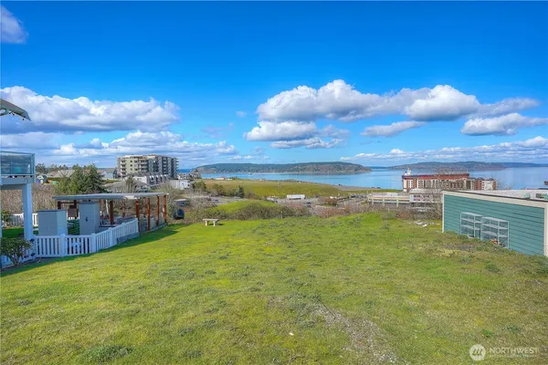 a view of a lake with lawn chairs