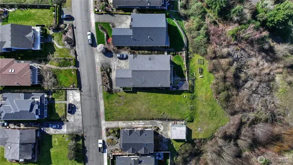 an aerial view of a house with a yard