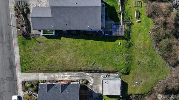 an aerial view of multiple houses with a yard