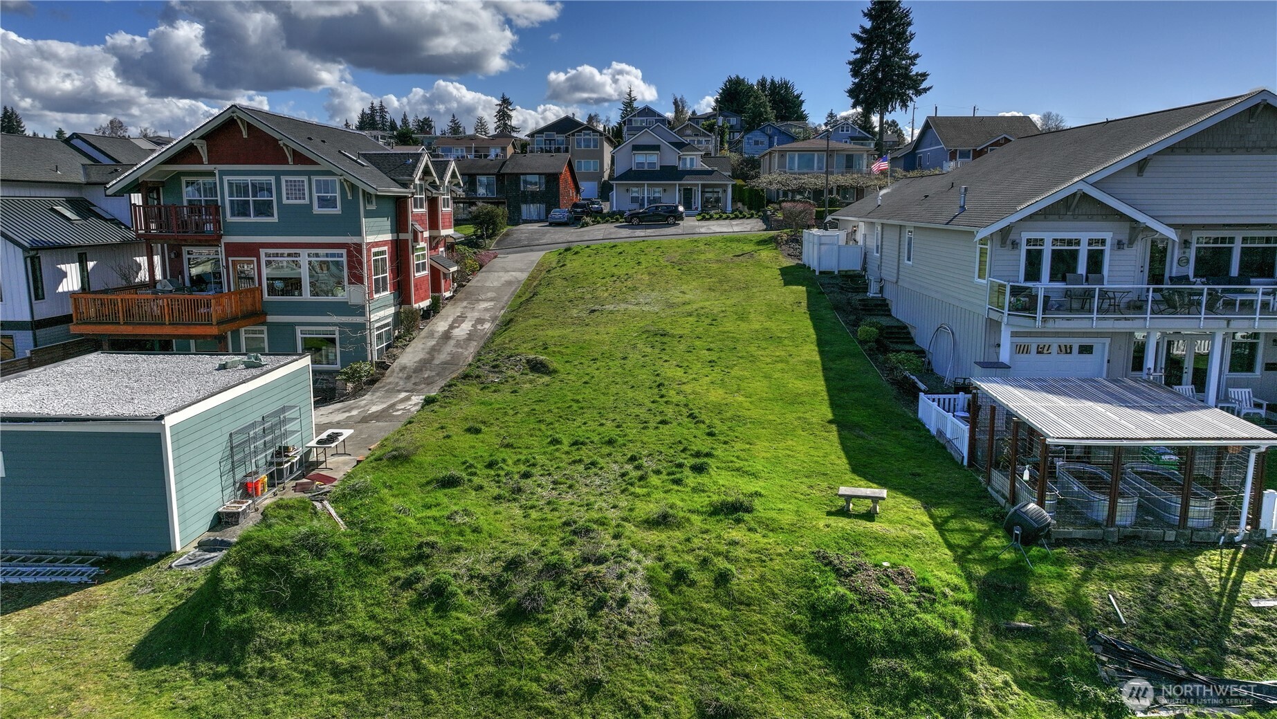 5313 North Commercial Street Ruston, WA 98407 - Photo 22 of 35 a aerial view of a house with swimming pool and large trees