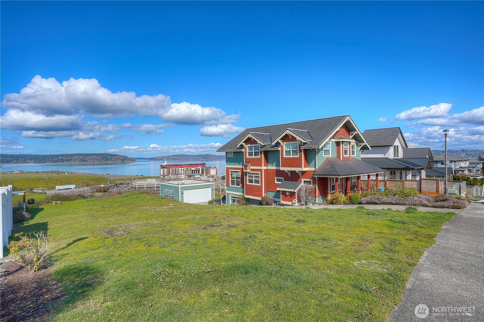 5313 North Commercial Street Ruston, WA 98407 - Photo 24 of 35 a view of a house with a big yard and large trees