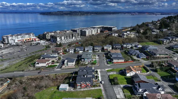 an aerial view of residential house with outdoor space and trees all around