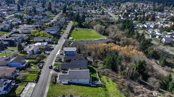 an aerial view of residential houses with yard