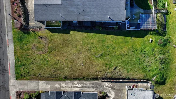an aerial view of a house with a yard