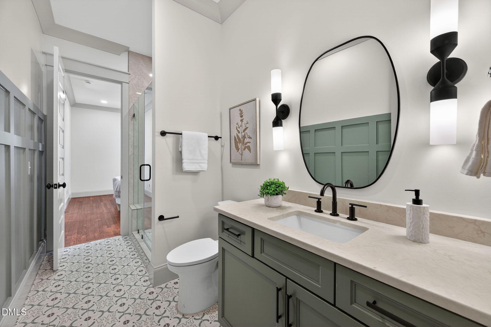 504 Tilden Street Raleigh, NC 27605 - Photo 13 of 58 a bathroom with a toilet a sink and mirror