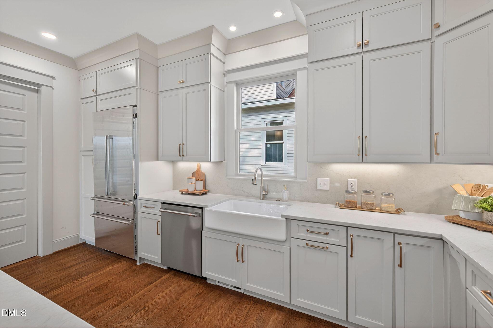 504 Tilden Street Raleigh, NC 27605 - Photo 19 of 58 a kitchen with stainless steel appliances granite countertop a sink and cabinets
