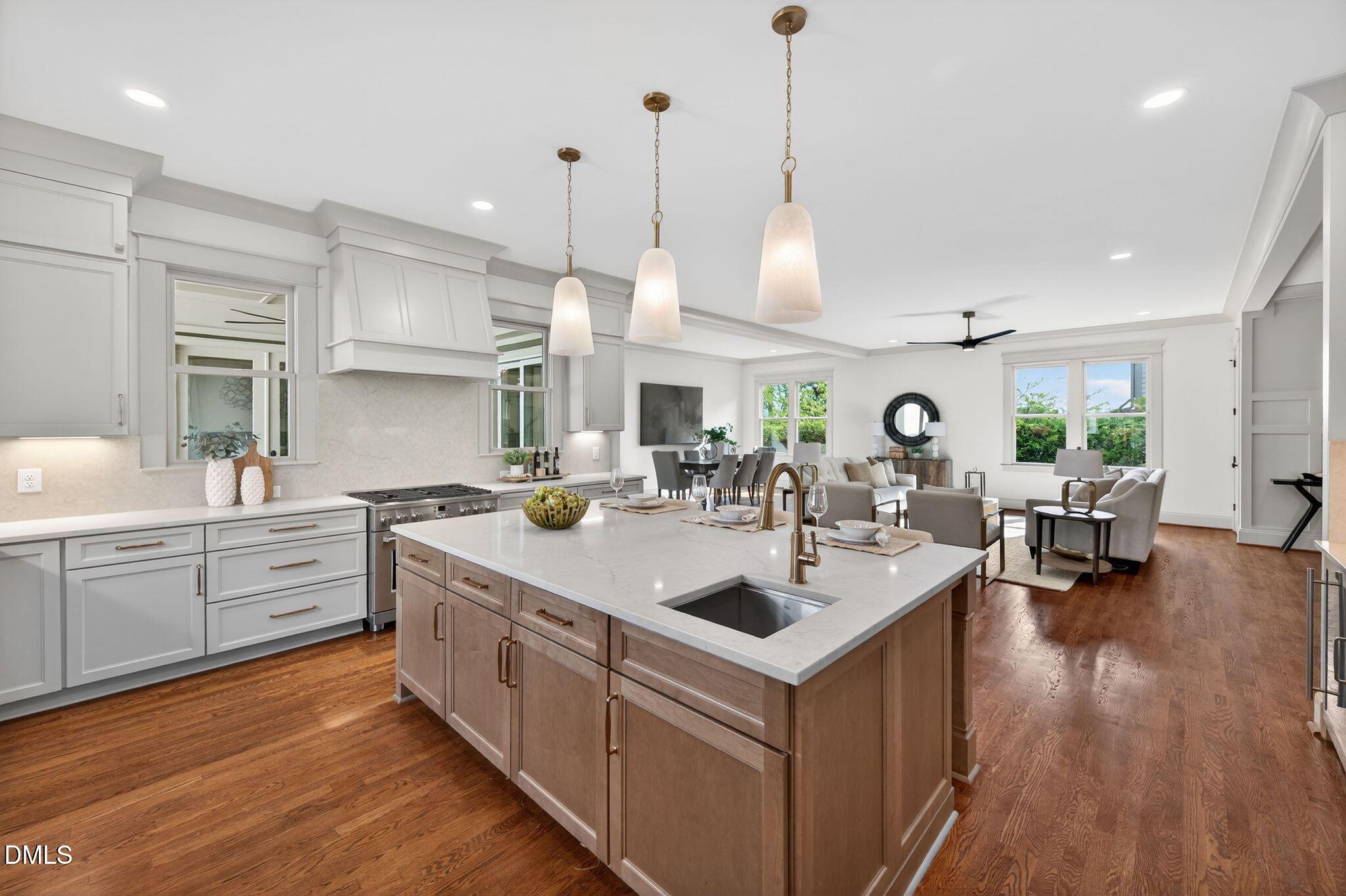 504 Tilden Street Raleigh, NC 27605 - Photo 20 of 58 a kitchen with stainless steel appliances granite countertop a sink a stove and a wooden floor