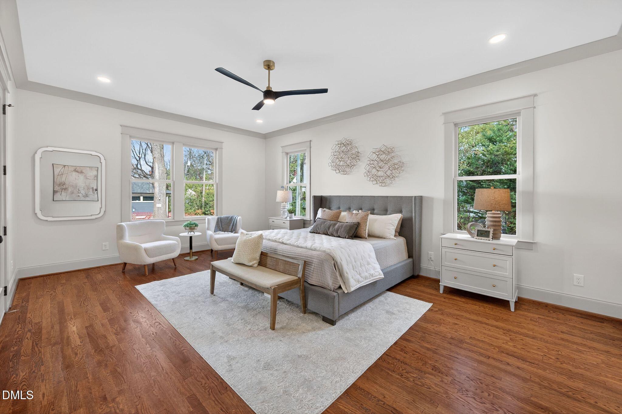 504 Tilden Street Raleigh, NC 27605 - Photo 25 of 58 a spacious bedroom with a bed couch and a window