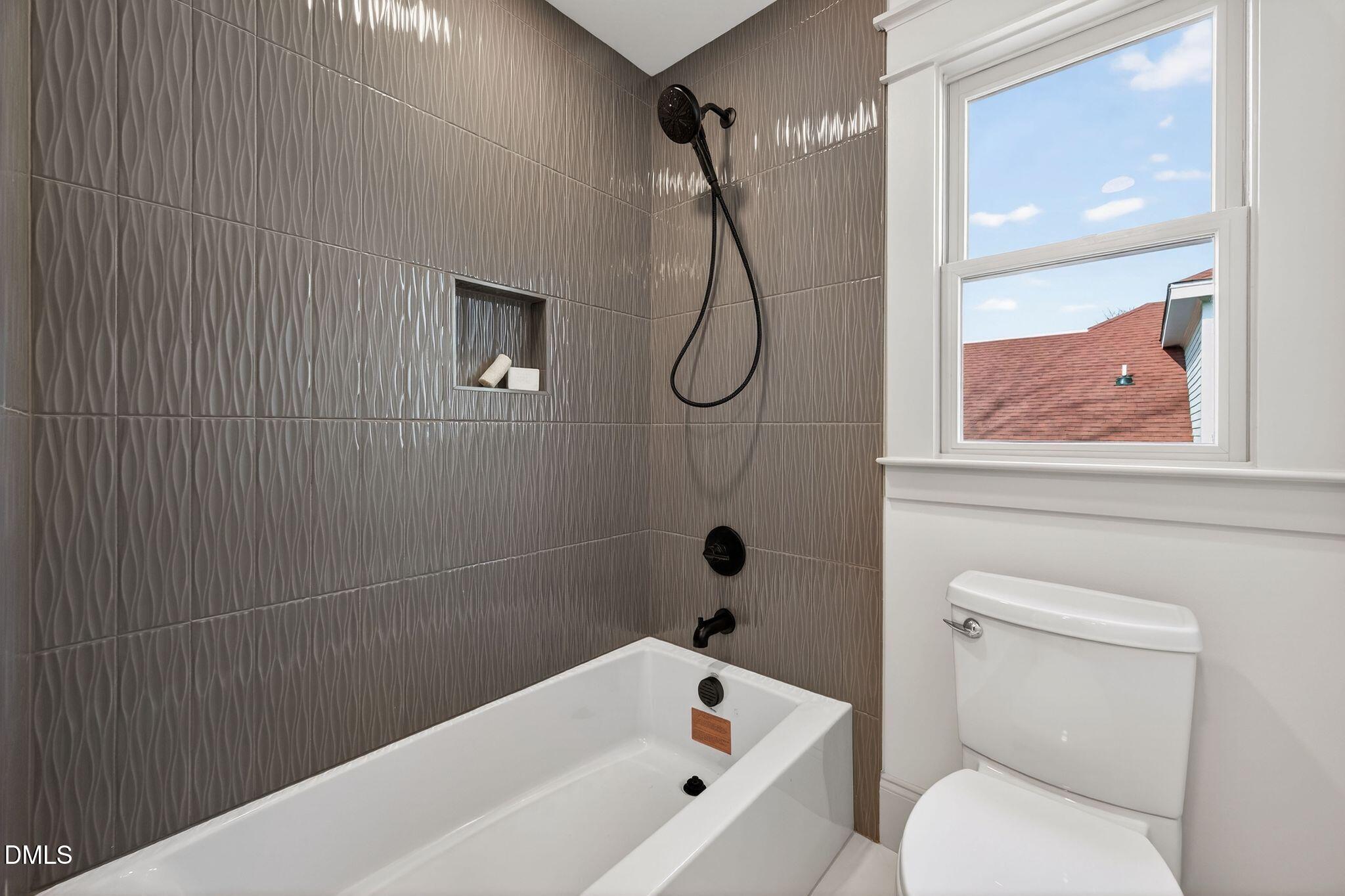 504 Tilden Street Raleigh, NC 27605 - Photo 38 of 58 a bathroom with a toilet and white tub