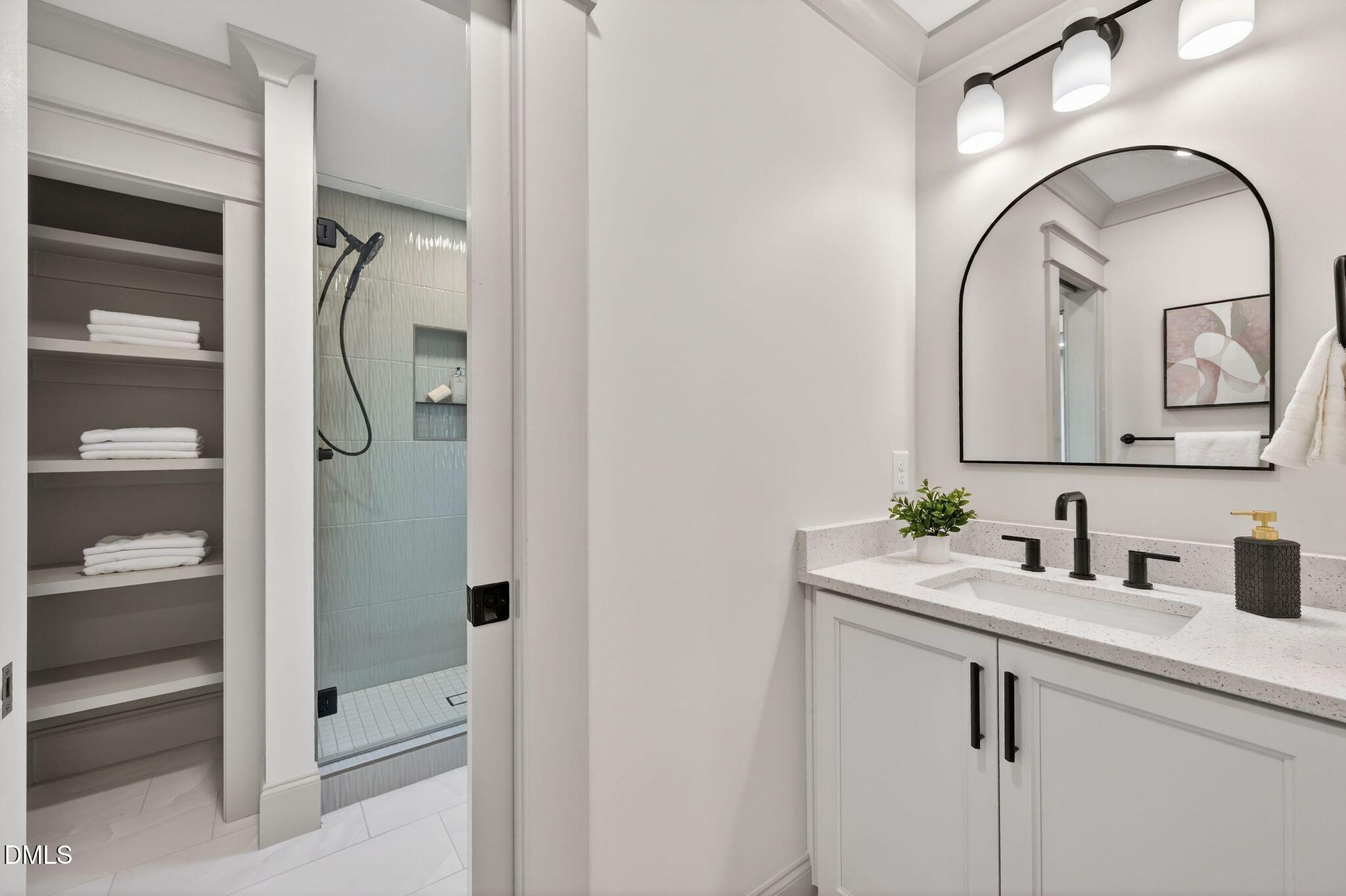 504 Tilden Street Raleigh, NC 27605 - Photo 42 of 58 a bathroom with a sink and mirror