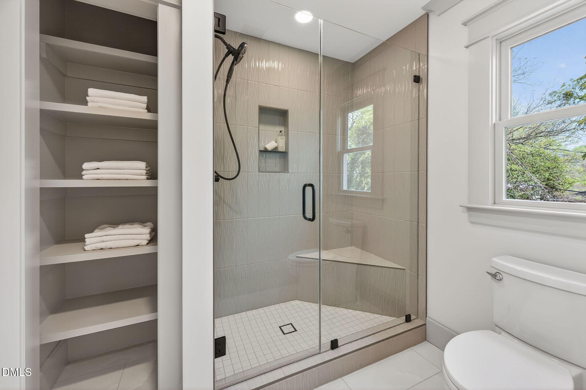 504 Tilden Street Raleigh, NC 27605 - Photo 43 of 58 a bathroom with a glass shower door