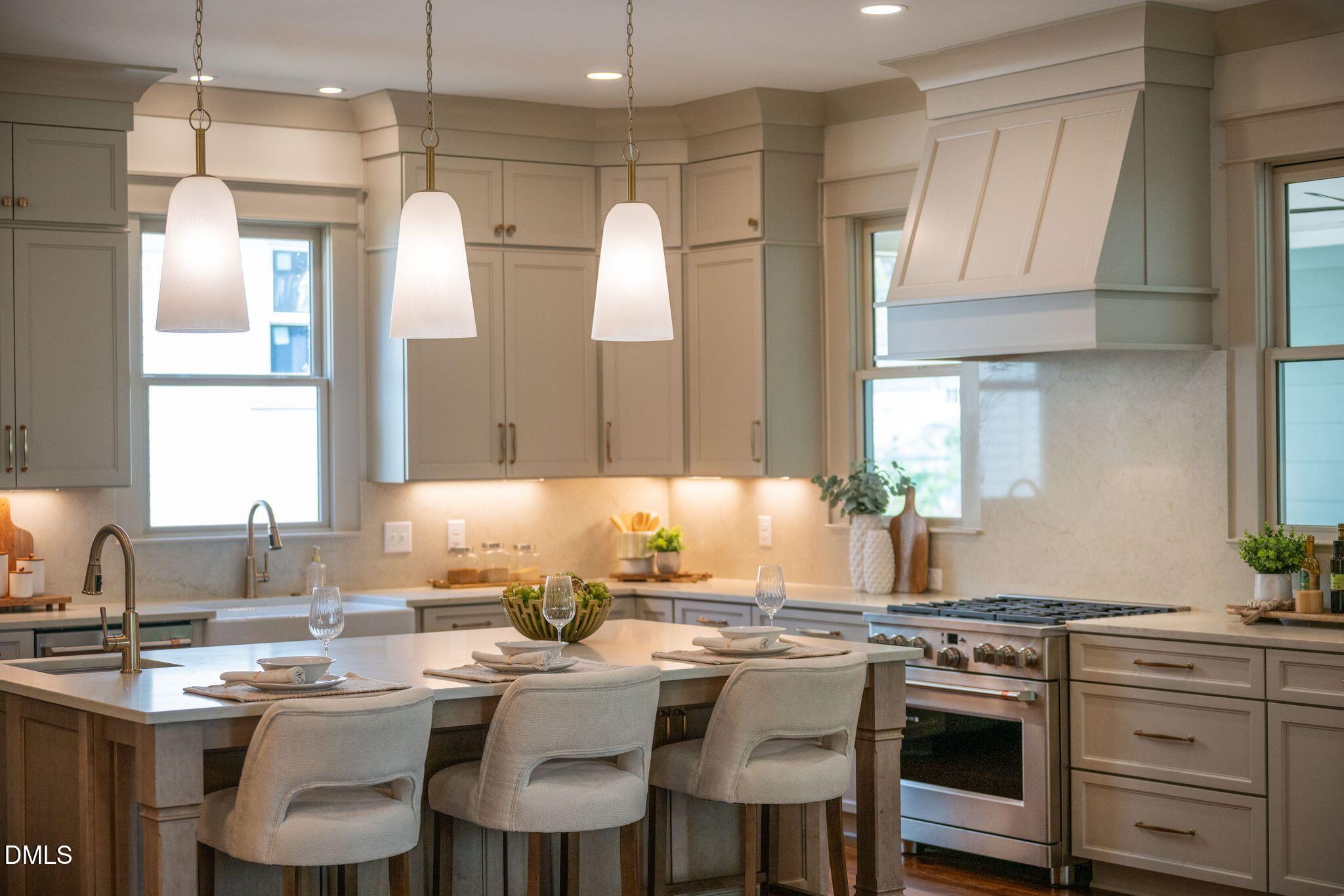 504 Tilden Street Raleigh, NC 27605 - Photo 50 of 58 a kitchen with a table chairs sink and cabinets
