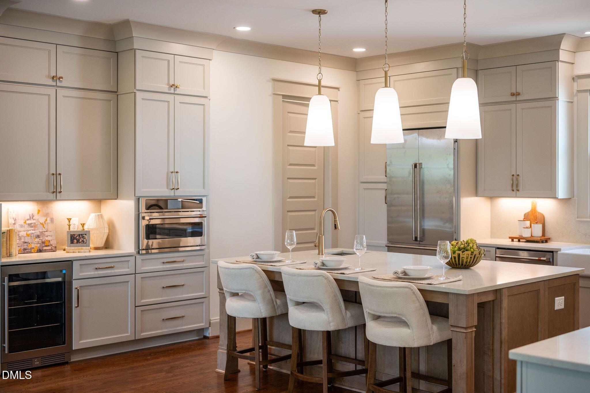 504 Tilden Street Raleigh, NC 27605 - Photo 51 of 58 a kitchen with stainless steel appliances kitchen island granite countertop a table chairs sink and cabinets
