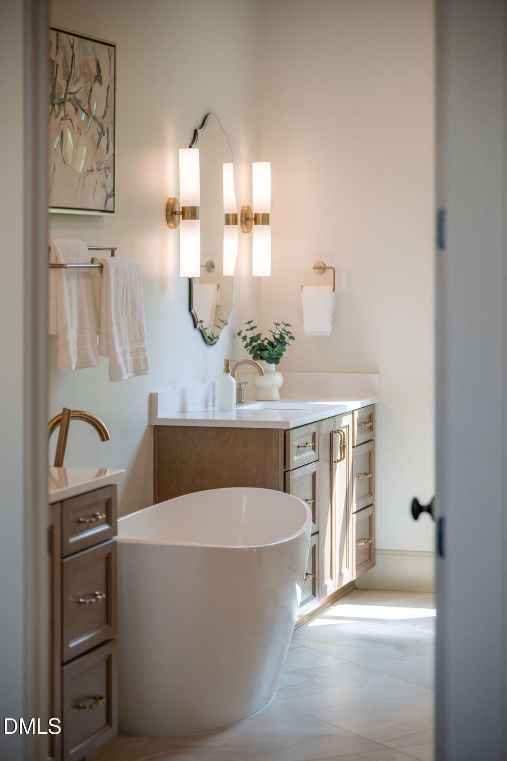 504 Tilden Street Raleigh, NC 27605 - Photo 52 of 58 a bathroom with a bathtub a sink and a mirror