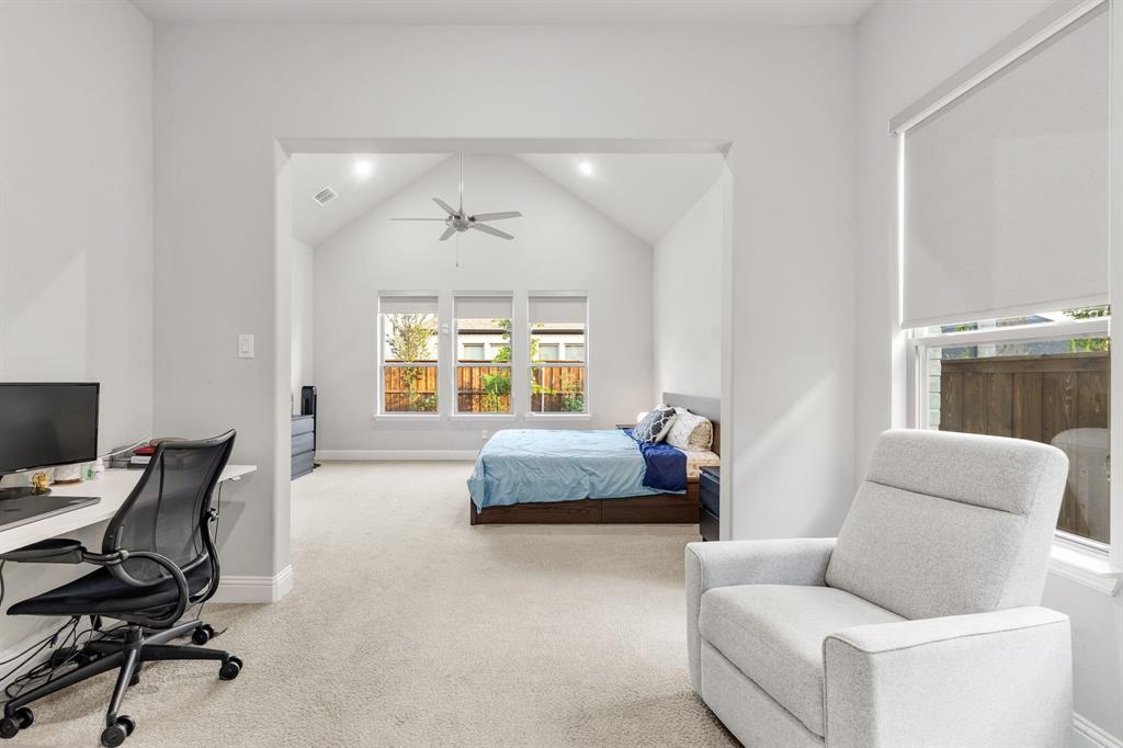7852 Buffaloberry Road Frisco, TX 75035 - Photo 16 of 36 Spacious bedroom featuring vaulted ceilings, a ceiling fan, recessed lighting, and light-colored carpeting