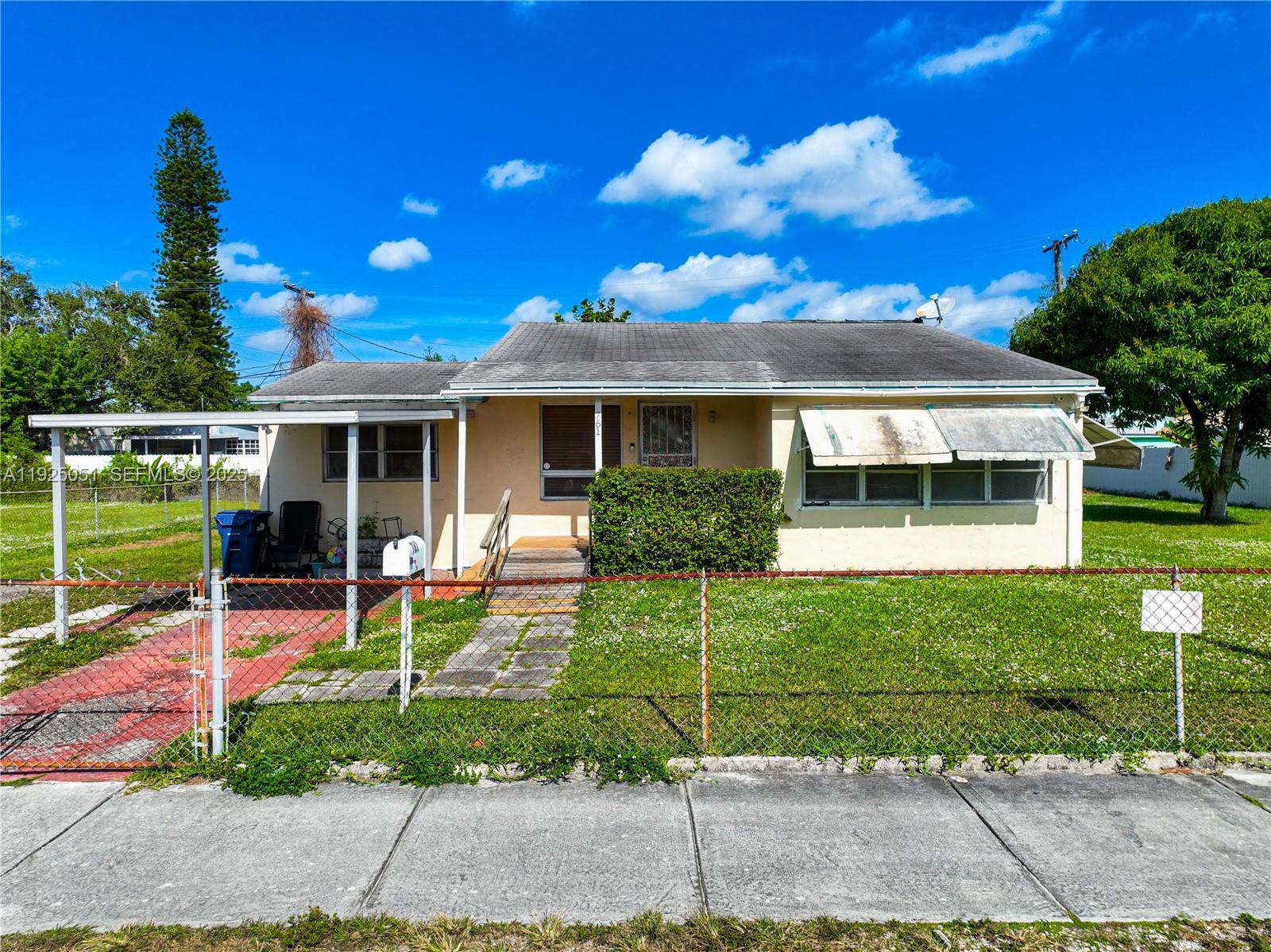 761 Northwest 74th Street Miami, FL 33150 - Photo 2 of 23 a view of a house with sitting area and garden