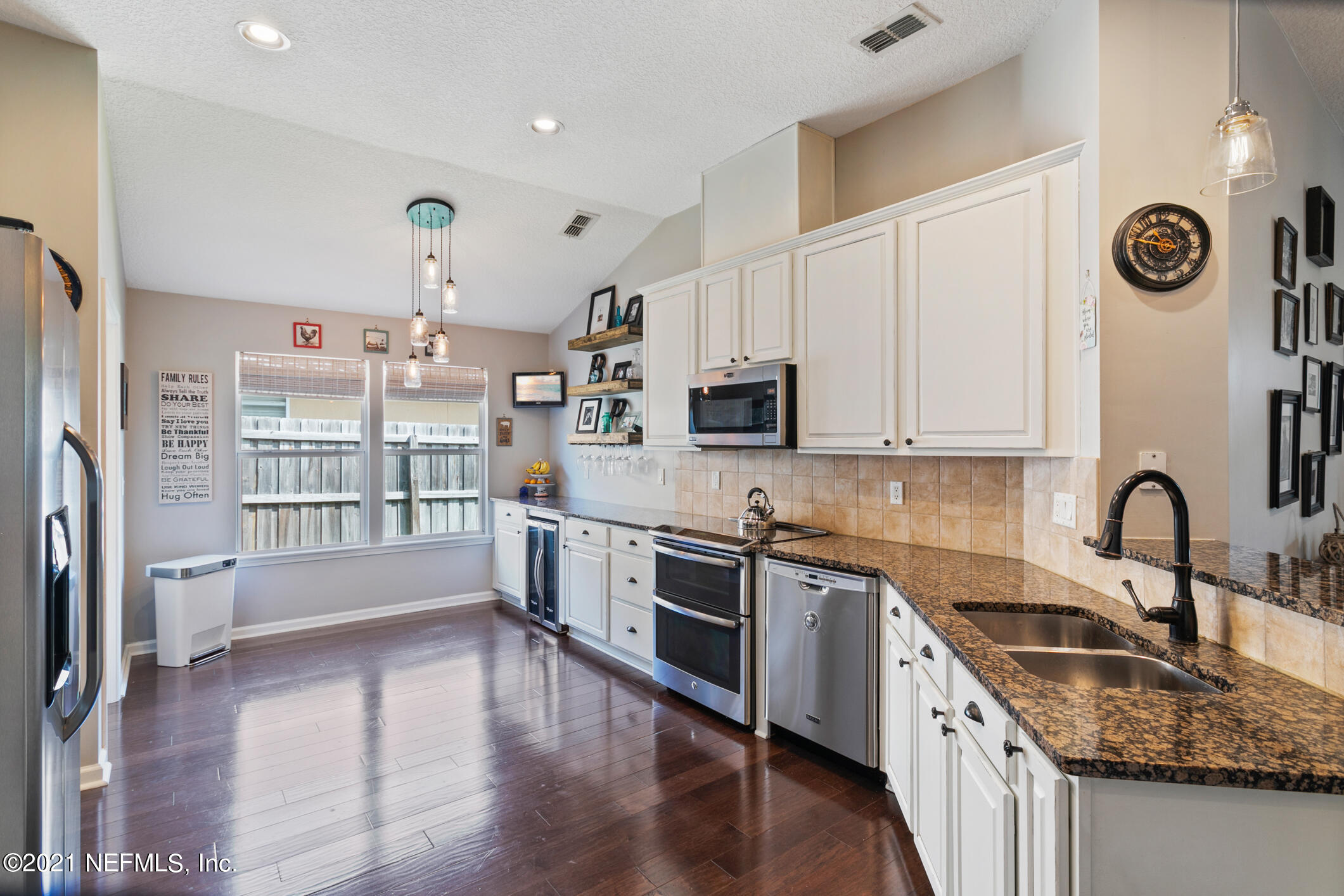 768 West Devonhurst Lane Ponte Vedra, FL 32081 - Photo 18 of 49 a kitchen with stainless steel appliances granite countertop a sink cabinets and wooden floor