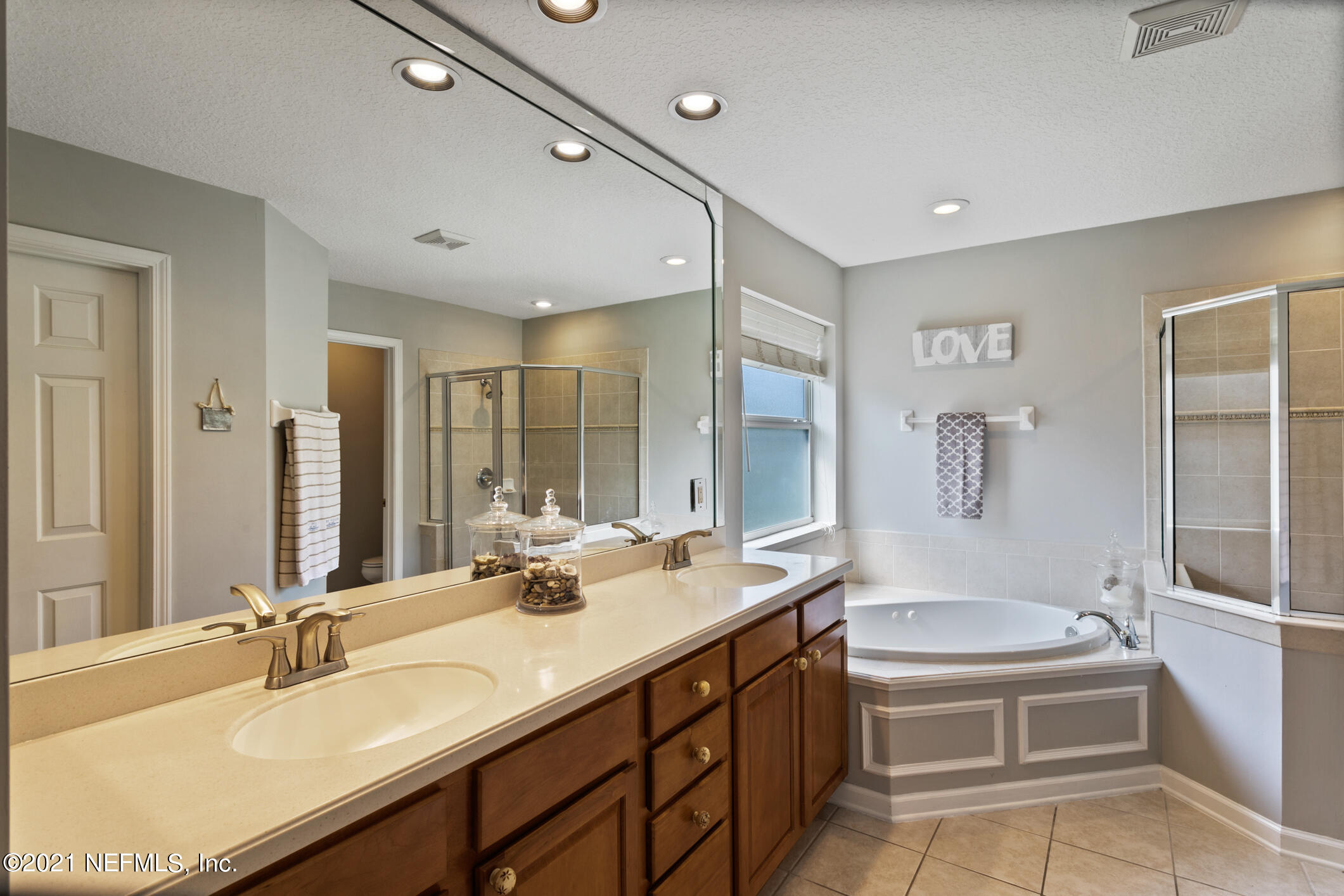 768 West Devonhurst Lane Ponte Vedra, FL 32081 - Photo 25 of 49 a bathroom with a double vanity sink a mirror a bathtub and shower