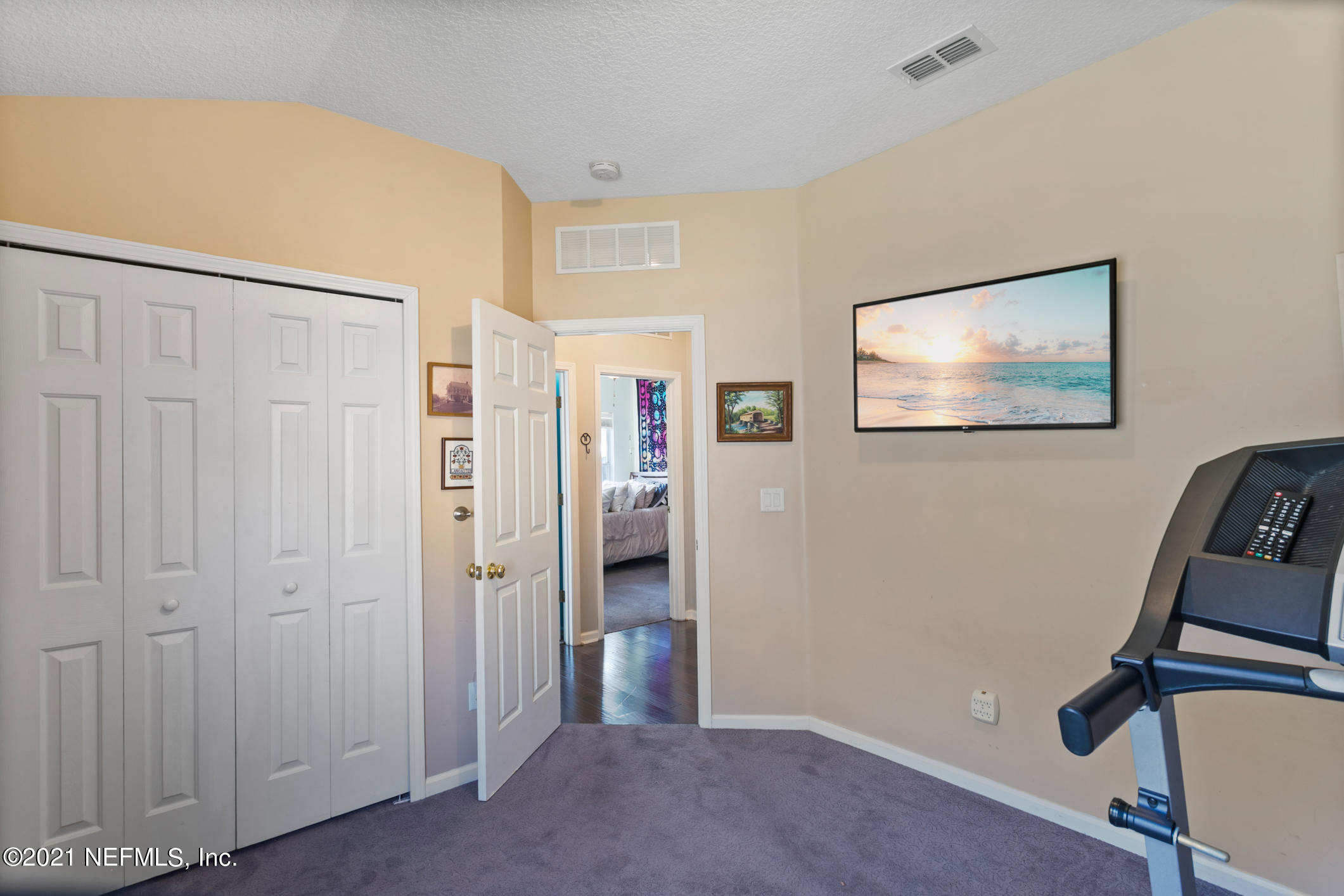 768 West Devonhurst Lane Ponte Vedra, FL 32081 - Photo 30 of 49 a view of a hallway with paintings on the wall