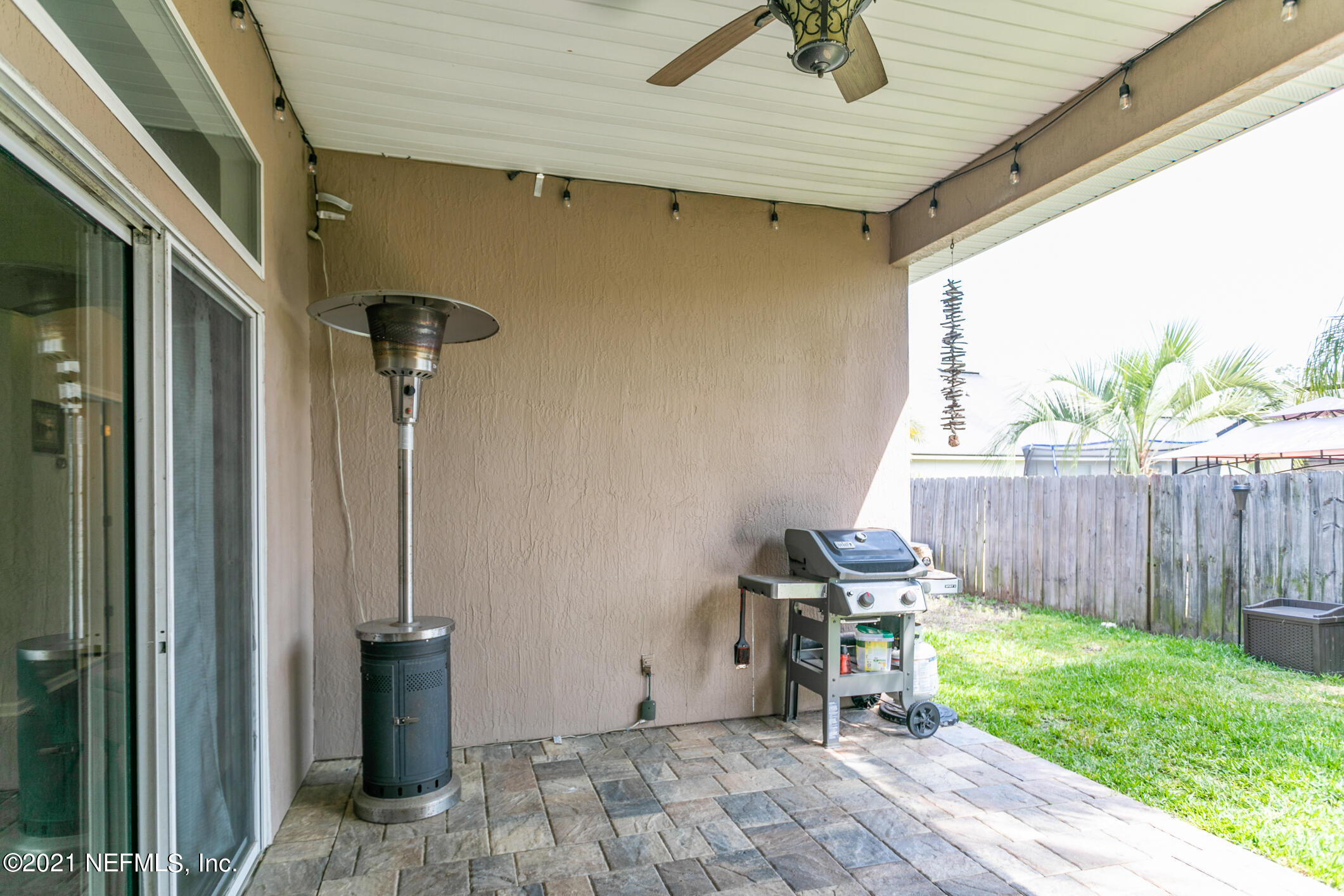 768 West Devonhurst Lane Ponte Vedra, FL 32081 - Photo 5 of 49 a view of a backyard with table and chairs with wooden fence