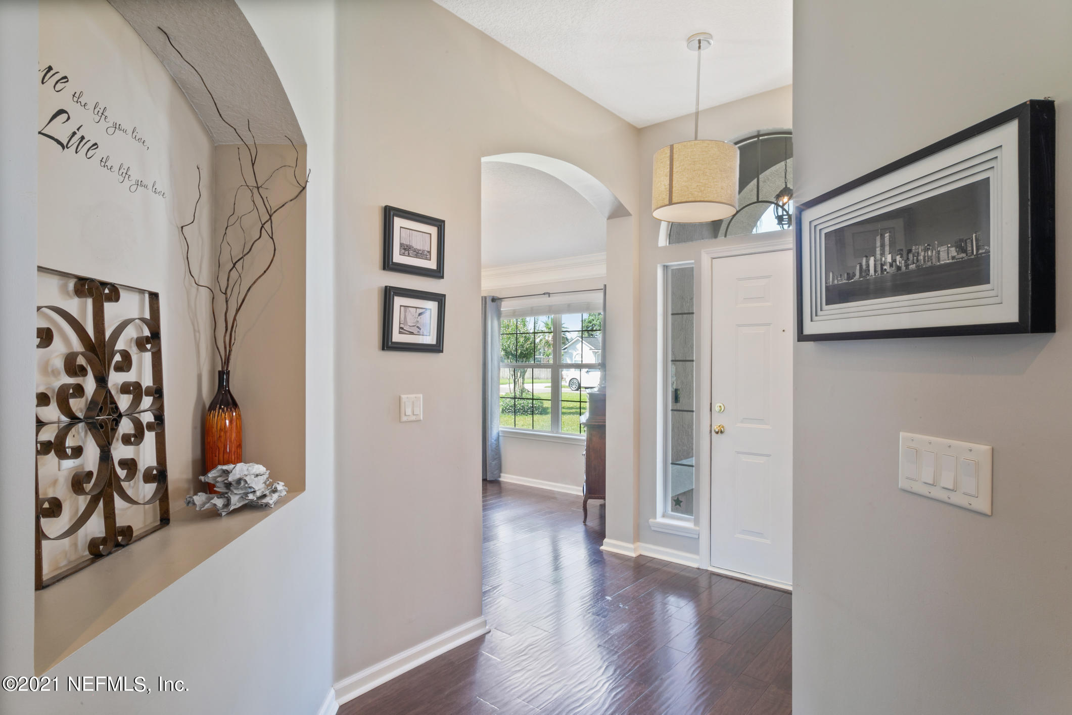 768 West Devonhurst Lane Ponte Vedra, FL 32081 - Photo 9 of 49 a view of a hallway with wooden floor and a dining room